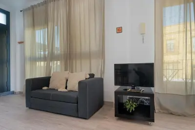 a living room with a couch and a flat screen tv at Panther Home Aladro V in Jerez de la Frontera