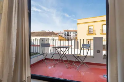 a view of two chairs and a table on a balcony at Panther Home Aladro V in Jerez de la Frontera