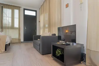 a living room with a couch and a flat screen tv at Panther Home Aladro V in Jerez de la Frontera