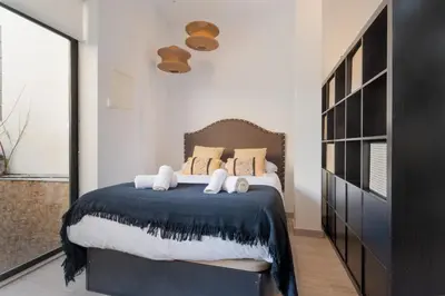 a bedroom with a bed with towels on it at Panther Home Aladro IV in Jerez de la Frontera