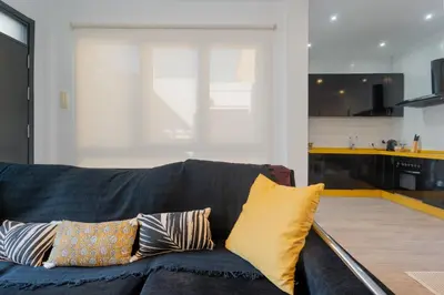 a living room with a blue couch with pillows at Panther Home Aladro IV in Jerez de la Frontera