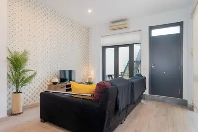 a living room with a couch and a television at Panther Home Aladro IV in Jerez de la Frontera