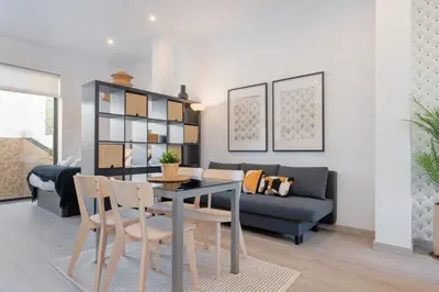 a living room with a table and chairs and a couch at Panther Home Aladro IV in Jerez de la Frontera