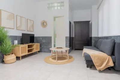 a living room with a couch and a table at Panther Home Aladro in Jerez de la Frontera