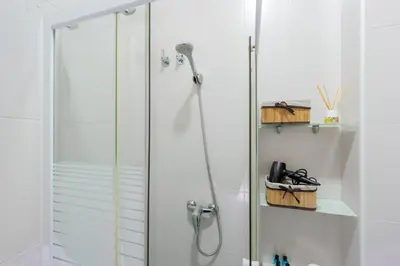 a shower with a glass door in a bathroom at Panther Home Aladro in Jerez de la Frontera