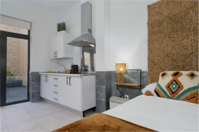 a kitchen with a bed and a white counter top at Panther Home Aladro in Jerez de la Frontera