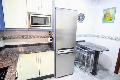 a refrigerator in a kitchen with a table at Apartamento SERAFÍN de la Caleta in Cádiz