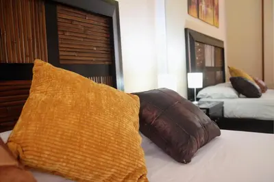 a bedroom with two beds and two pillows on a bed at Apartamento SERAFÍN de la Caleta in Cádiz