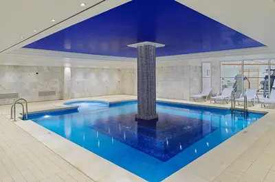 a large swimming pool in a building with at Hipotels Sherry Park in Jerez de la Frontera