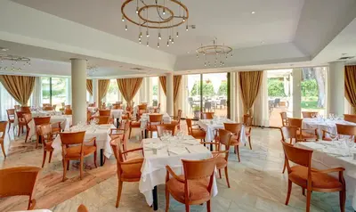a dining room with white tables and chairs at Hipotels Sherry Park in Jerez de la Frontera