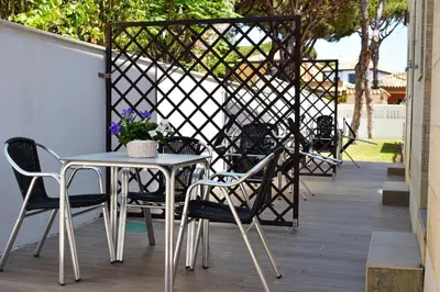 a table and chairs sitting on a patio at Aparthotel Novo Sancti Petri in Chiclana de la Frontera