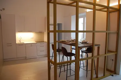 a kitchen with a table and chairs in a room at Guesting Basílica in Jerez de la Frontera