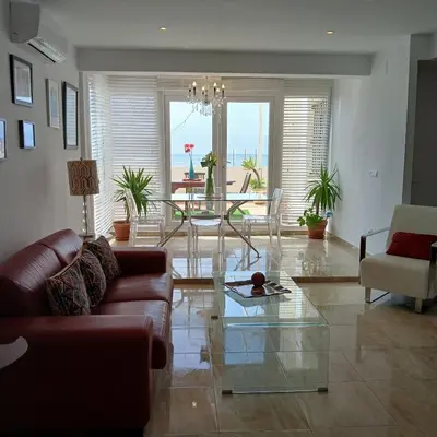 a living room with a glass table and chairs at AMAZING FRONTAL BEACH APARTMENT #Traveller's Awards2023 in Cádiz