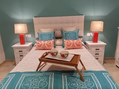 a bedroom with a bed with two tables and two lamps at AMAZING FRONTAL BEACH APARTMENT #Traveller's Awards2023 in Cádiz