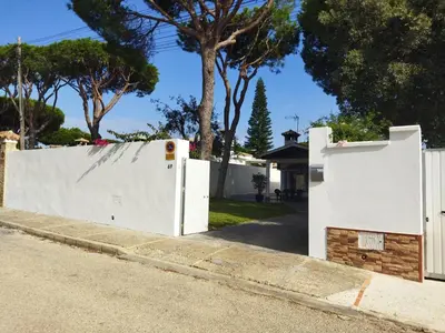 a white fence on the side of a street at Chalet Costa de la Luz - La Barrosa in Chiclana de la Frontera