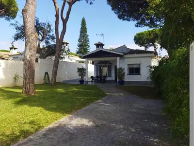 a white house with a pathway in front of it at Chalet Costa de la Luz - La Barrosa in Chiclana de la Frontera