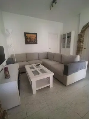a living room with a couch and a coffee table at Chalet Costa de la Luz - La Barrosa in Chiclana de la Frontera