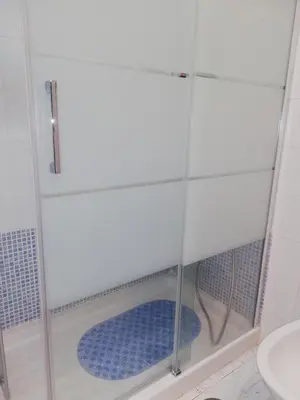 a shower stall with a blue mat in a bathroom at Chalet Costa de la Luz - La Barrosa in Chiclana de la Frontera