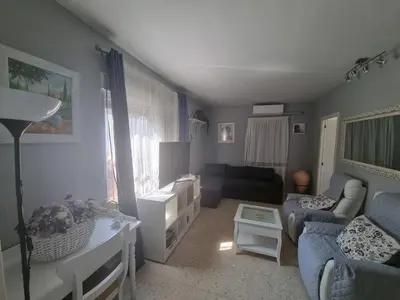 a living room with a couch and a table at Carretera Pinar de los Franceses JAZMIN in Chiclana de la Frontera