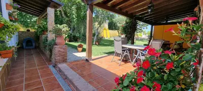 an outdoor patio with a table and a fireplace at Carretera Pinar de los Franceses JAZMIN in Chiclana de la Frontera