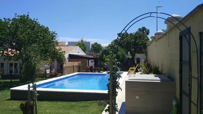 a swimming pool in a yard next to a house at Carretera Pinar de los Franceses JAZMIN in Chiclana de la Frontera