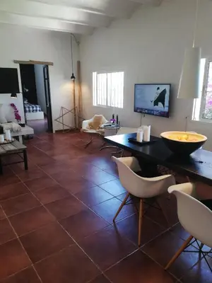a living room with a tiled floor with a table and chairs at Casa MariSol in Arcos de la Frontera