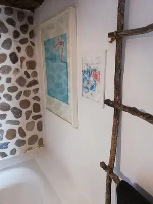 a bathroom with two pictures on the wall at Casa MariSol in Arcos de la Frontera