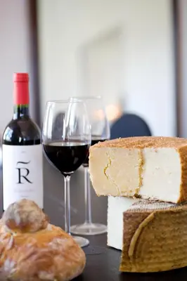 a glass of wine and some bread and a bottle of wine at Casa MariSol in Arcos de la Frontera
