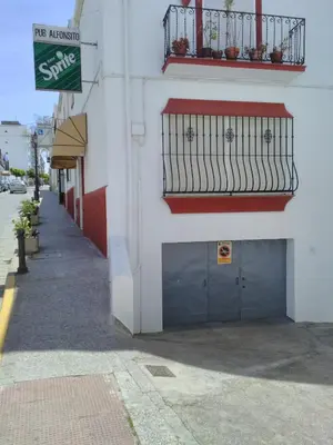 a white building with a door and a balcony at Casa MariSol in Arcos de la Frontera