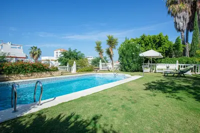 a swimming pool in the yard of a house at Charming villa in Sanlúcar de Barrameda with private pool in Sanlúcar de Barrameda