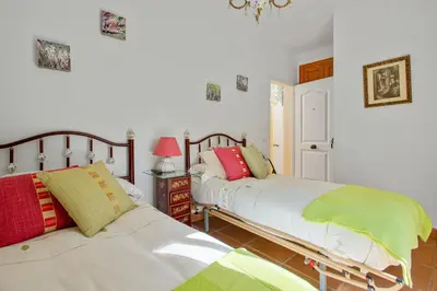two beds sitting next to each other in a bedroom at Charming villa in Sanlúcar de Barrameda with private pool in Sanlúcar de Barrameda