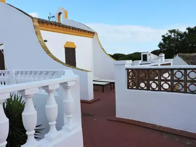 a white house with a white fence and a balcony at Spacious Villa in Conil de Frontera with Private Pool in Roche
