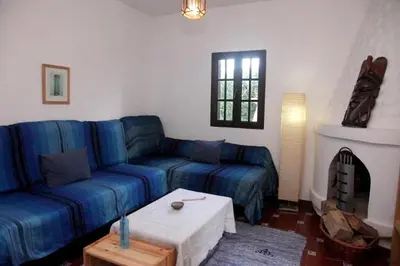 a living room with a blue couch and a table at Spacious Villa in Conil de Frontera with Private Pool in Roche