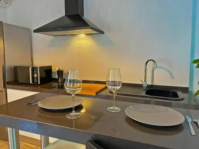 two glasses of wine sitting on a kitchen counter at Apartamento Vitoria. in Jerez de la Frontera