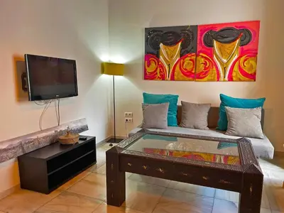a living room with a couch and a flat screen tv at Apartamento Vitoria. in Jerez de la Frontera