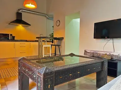 a living room with a glass table in the middle at Apartamento Vitoria. in Jerez de la Frontera