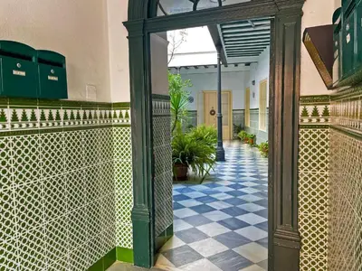an entrance to a building with a tile floor at Apartamento Vitoria. in Jerez de la Frontera