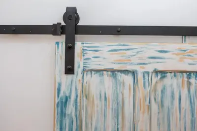 a curtain rod with a painting hanging on a wall at Noah House city center - Historic center in Cádiz