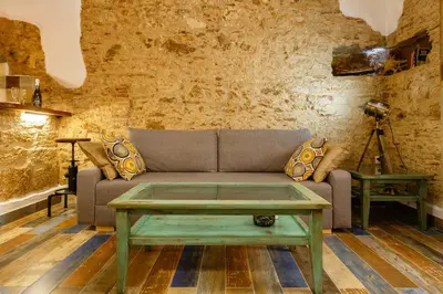 a living room with a couch and a table at Noah House city center - Historic center in Cádiz