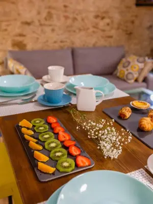 a table topped with plates of sushi and vegetables at Noah House city center - Historic center in Cádiz