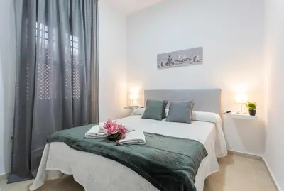 a bedroom with a bed with towels on it at Centro 4 Rooms 3 baños Parking in Jerez de la Frontera