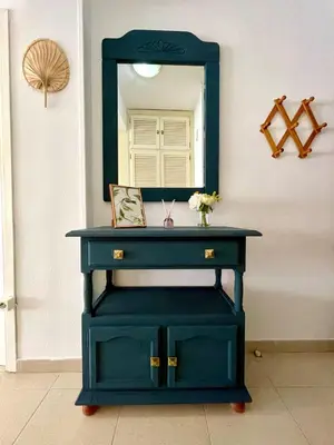 a blue dressing table with a mirror on a wall at GATU Verano en la playa con parking, wifi, piscina in El Puerto de Santa María