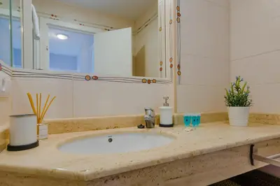 a bathroom with a sink and a mirror at Apartamento Sea Views Rota in Rota