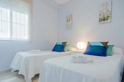 two beds sitting next to each other in a room at Apartamento Sea Views Rota in Rota