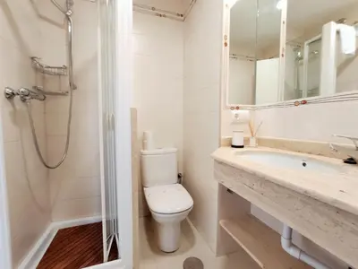 a bathroom with a toilet and a sink and a shower at Apartamento Sea Views Rota in Rota