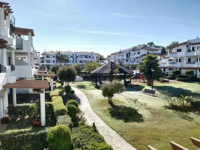 a view of a park with a gazebo and buildings at APARTAMENTO EN COTO DE SANCTI PETRI in Chiclana de la Frontera