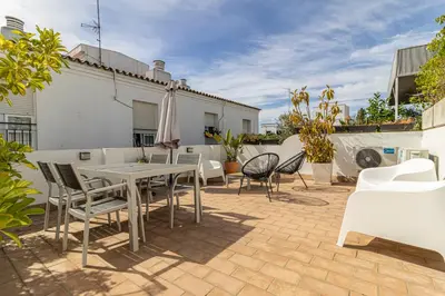 a patio with a table and chairs and a building at Exclusive Boutique in Jerez de la Frontera