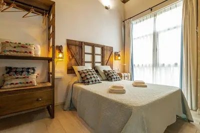 a bedroom with a bed with two towels on it at Exclusive Boutique in Jerez de la Frontera