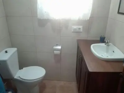 a bathroom with a toilet and a sink at Casa 100m2 in Chiclana de la Frontera