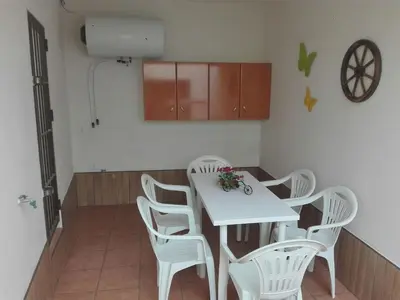 a kitchen with a white table and white chairs at Casa 100m2 in Chiclana de la Frontera